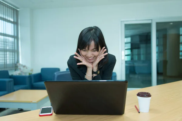 Business woman wow from laptop,Looking stock market,Happy thai woman concept,Secretary working in office
