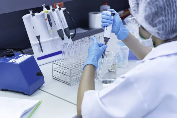 The Asian scientists injected chemicals into plastic tubes,Thailand scientist working in the Lab,Experiment in the laboratory