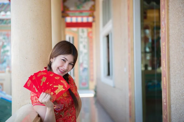 Portrait of beautiful asian woman in Cheongsam dress, Thailand people, Happy Chinese new year concept