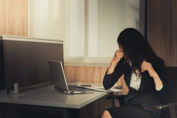 Asian businesswoman stress from hard work,Thai worker woman working in the office,Dark tone