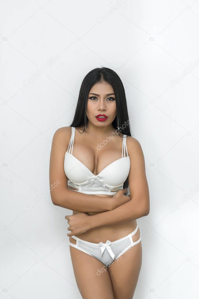 Portrait of sexy asian woman tan sit on chair pose for take a photo on white background,Fashion bra concept