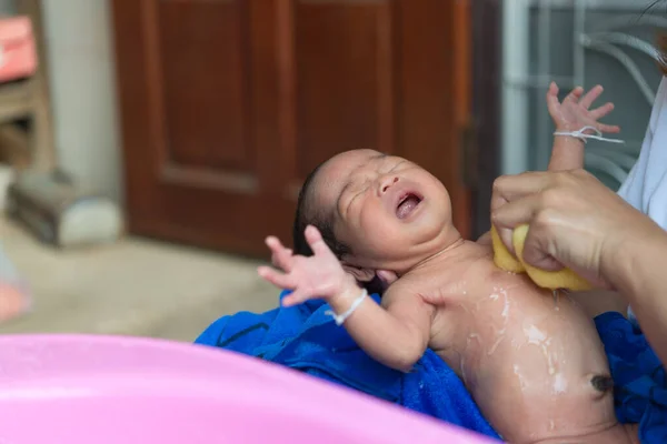 Closeup asian baby cry,thailand people,Closeup asian baby take a shower on daylight,newborn