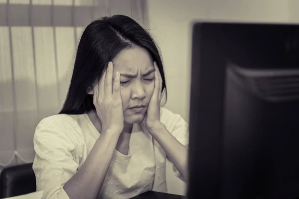 young business woman stressed from work overload while working in office