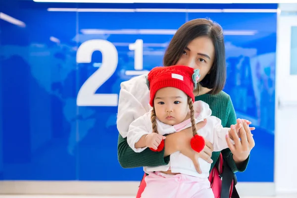 Young asian mom with daugther baby shopping at department store,Cute asian baby and mother use holiday with family,mother day concept