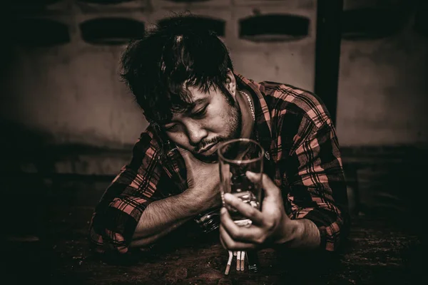 Asian man drink vodka alone at home on night time,Thailand people,Stress man drunk concept