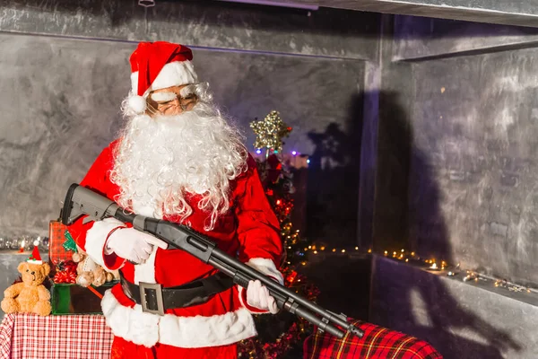 Angry Santa claus holding Shortgun at home,Sit on chair think about plan for sent gift box for give children
