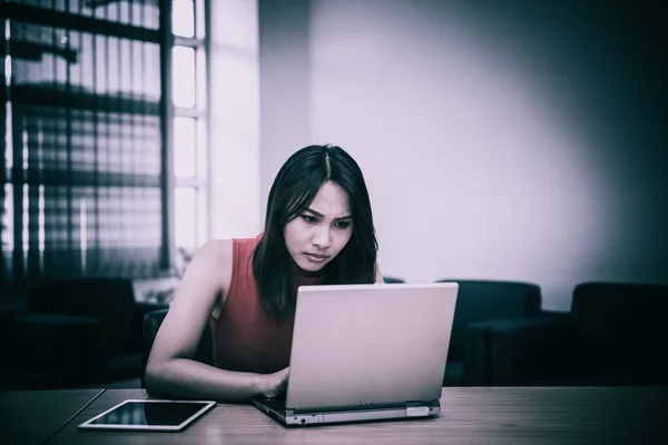 Business woman stress from hard work on the desk at office dark tone,Thailand people,Secretary sad from boss