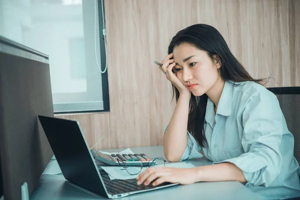 young business woman stressed from work overload while working in office