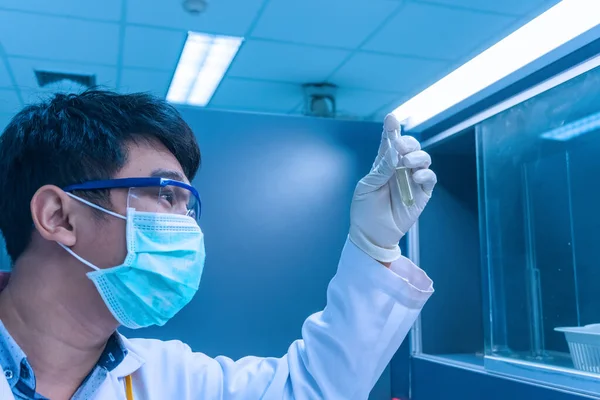 Scientist mix chemicals with The shake machine Before the experiment.Mixture laced with samples into test tubes,Thailand scientist working in the lab