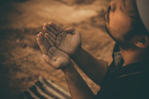 Silhouette Young asian muslim man praying on sunset,Ramadan festival concept