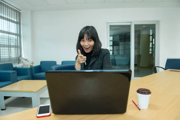 Business woman wow from laptop,Looking stock market,Happy thai woman concept,Secretary working in office