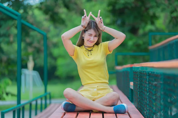 Cool Asian hipsters girl wear yellow dress posing for take a photo,lifestyle of modern woman,Thai people in hippie style,Chill day for relax