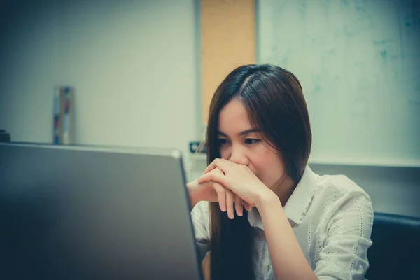 Asian office woman stress from work at the desk with laptop