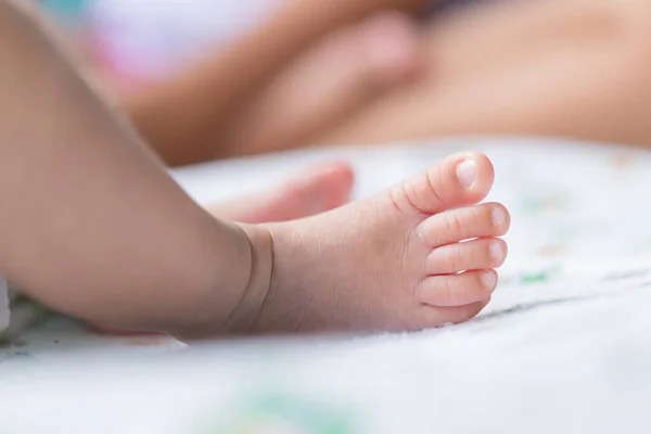 Closeup foot of asian baby on the bed