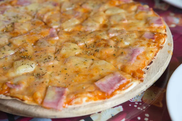 Thin crust pizza on a wooden tray,selective focus,low light,soft focus