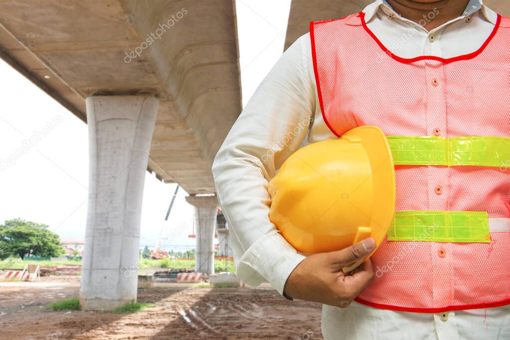 Asian foreman with blurry bridge under construction background