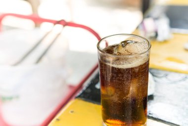 Buzlu kola, ahşap masada, yemek, köpük ve histerik içeceklerden önce içmek için.