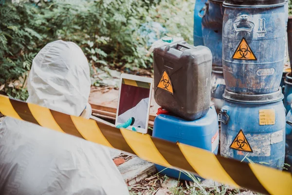 Asian scientist wear Chemical protection suit check danger chemical