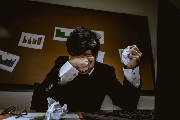 Asian businessman under stress during excessive work