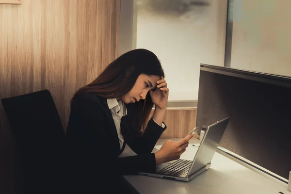 Asian businesswoman stress from hard work,Thai worker woman working in the office,Dark tone