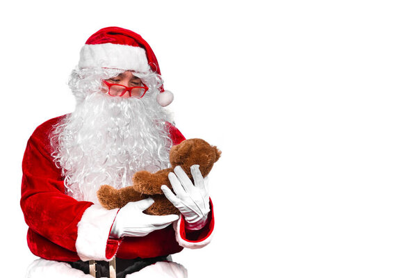 Santa claus holding teddy for children, Merry christmas concept