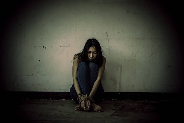 Asian hostage woman Bound with rope at night scene,The thieves kidnapped for ransom,thailand people