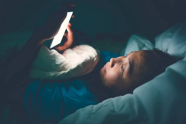 Asian woman play smartphone in the bed at night,Thailand people,Addict social media,Play internet all night,Lychnobite
