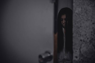 Asyalı kadın portresi hayalet yüzü, korku sahnesi, korkunç arka plan, Cadılar Bayramı posteri.