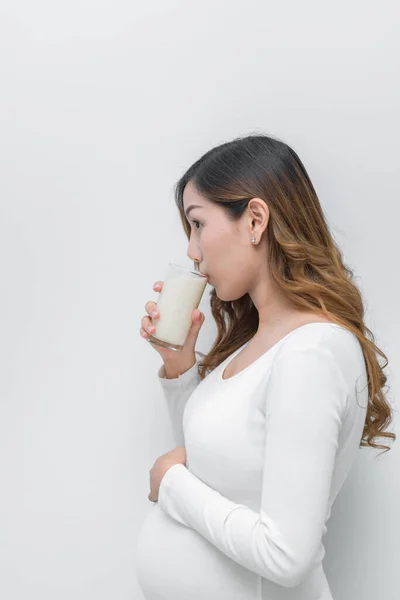 Pregnant woman with milk in her hand, Drinking milk good health to pregnancy