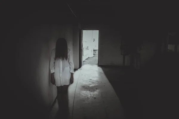 Close up woman wear white shirt in the dark room,Scary movie concept,Horror background,Thailand people