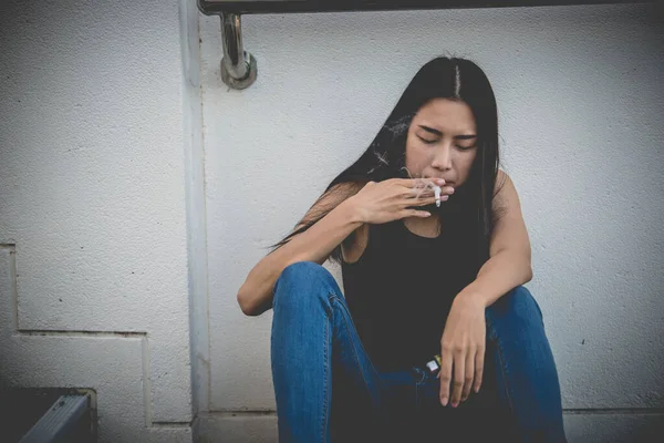 Asian woman sad from love,She smoking because stress from boyfriend,Heartbreak woman concept