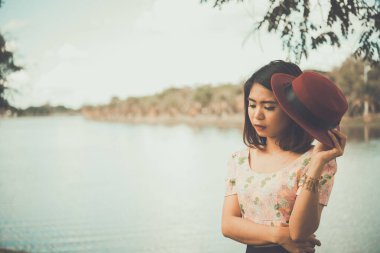 asian woman with red hat getting anxious