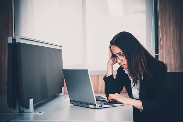 Asian businesswoman stress from hard work,Thai worker woman working in the office,Dark tone