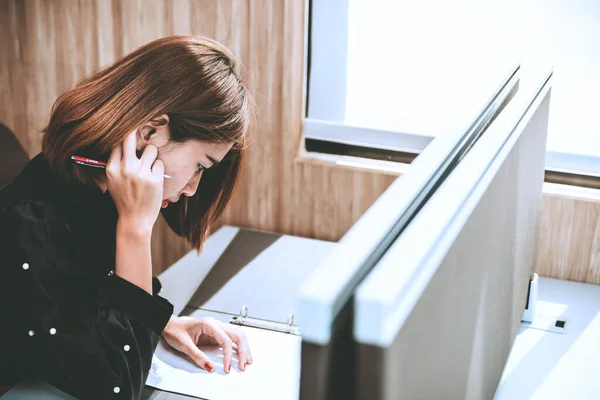 Asian woman working with the stress in the office.