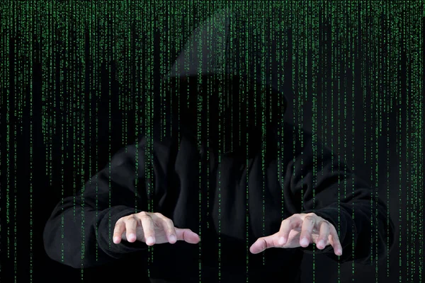 Asian hacker in black hood on black background