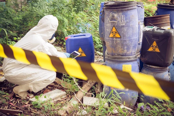 Asian scientist wear Chemical protection suit check danger chemical,working at dangerous zone,authenticating the dangerous chemicals