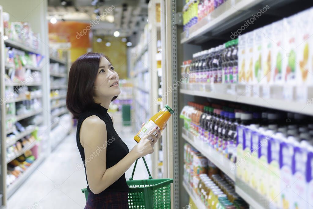 Beautiful asian woman walking shopping in supermarket