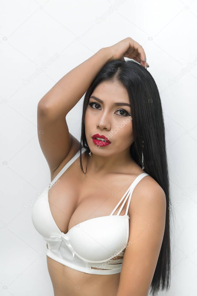 Portrait of sexy asian woman tan sit on chair pose for take a photo on white background,Fashion bra concept