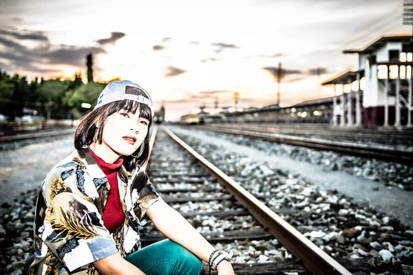 鉄道での日没のアジアのヒップスター女の子の肖像 — ストック写真