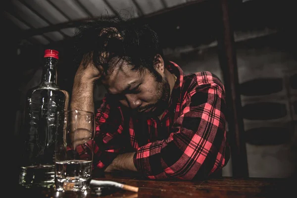 Asian man drink vodka alone at home on night time,Thailand people,Stress man drunk concept