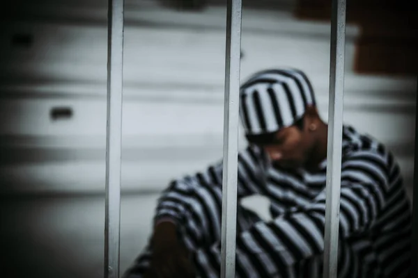 Portrait of Asian men desperate to catch the iron prison,prisoner concept,thailand people,Hope to be free.