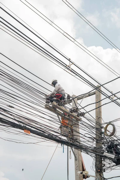 stock image Nakhonratchasima,THAILAND September 25:Electricians are replacing the mains cable on the high voltage poles.on 25 september 2016 in Nakhonratchasima,Thailand