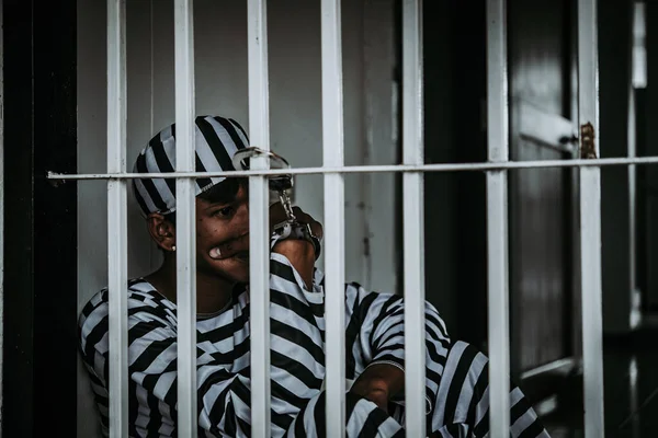 Hands of man desperate to catch the iron prison,prisoner concept,thailand people,Hope to be free.