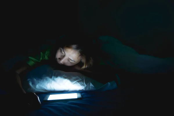 Asian woman play smartphone in the bed at night,Thailand people,Addict social media,Play internet all night