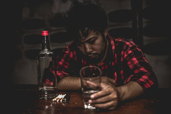 Asian man drink vodka alone at home on night time,Thailand people,Stress man drunk concept