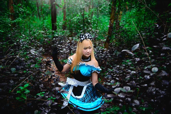 Princess in forest concept,Beautiful asian woman wear princess dress for talk a photo in the forest,thailand people,After rain