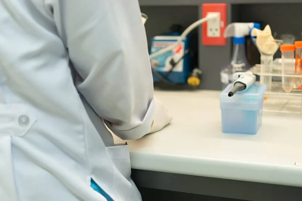 Scientist mix chemicals with The shake machine Before the experiment.Mixture laced with samples into test tubes,Thailand scientist working in the lab