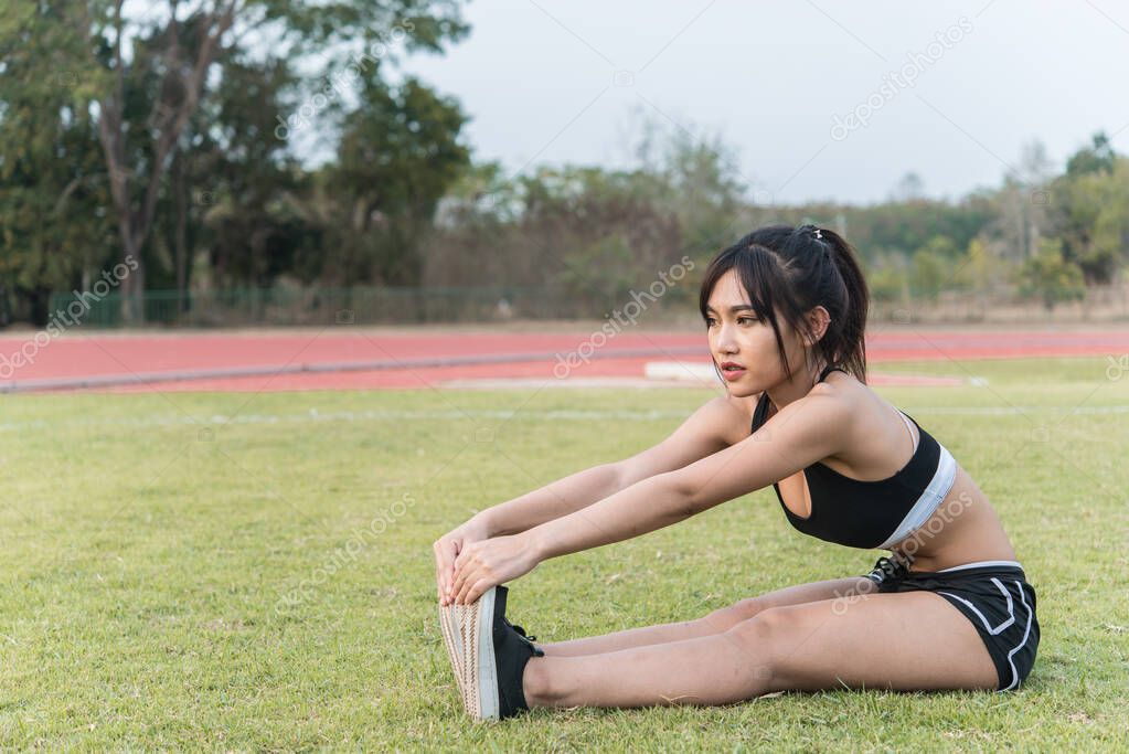 Beautiful asian woman stretching body in the field,Thailand people