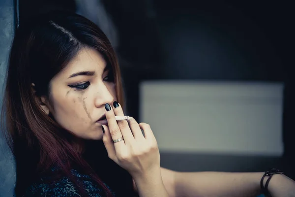 Asian woman sad from love,She smoking because stress from boyfriend,Heartbreak woman concept