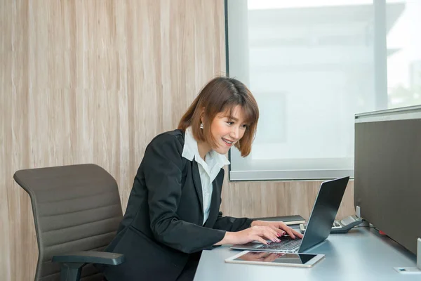 Asian woman working overtime in the office